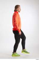   Erling  1 black pants dressed orange long sleeve t shirt side view sports walking whole body yellow sneakers 0003.jpg